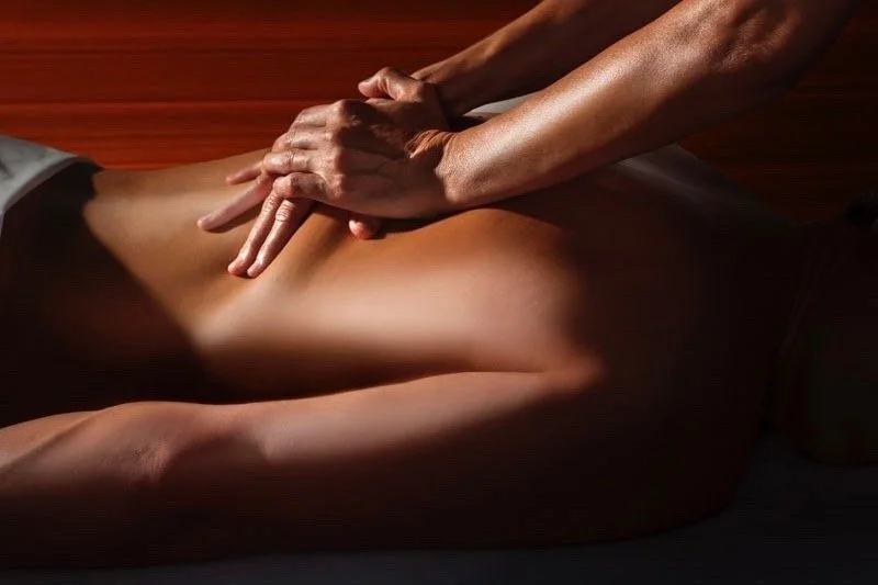 Hands working along the spine in warm low light