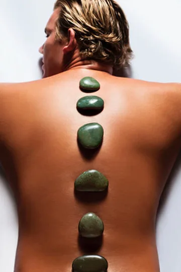 Hot rocks placed along the spine of water polo player John Mann