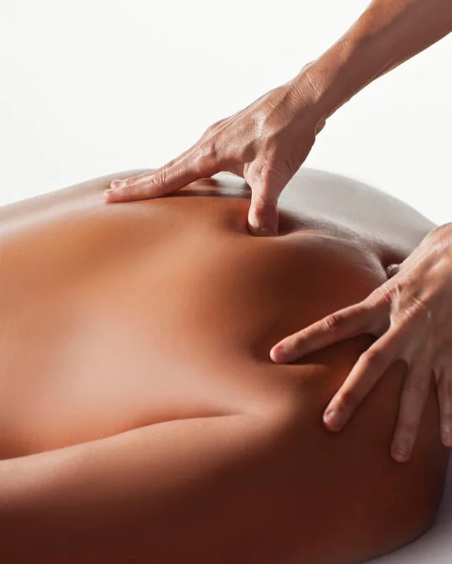 Marlo working along a client's lower back